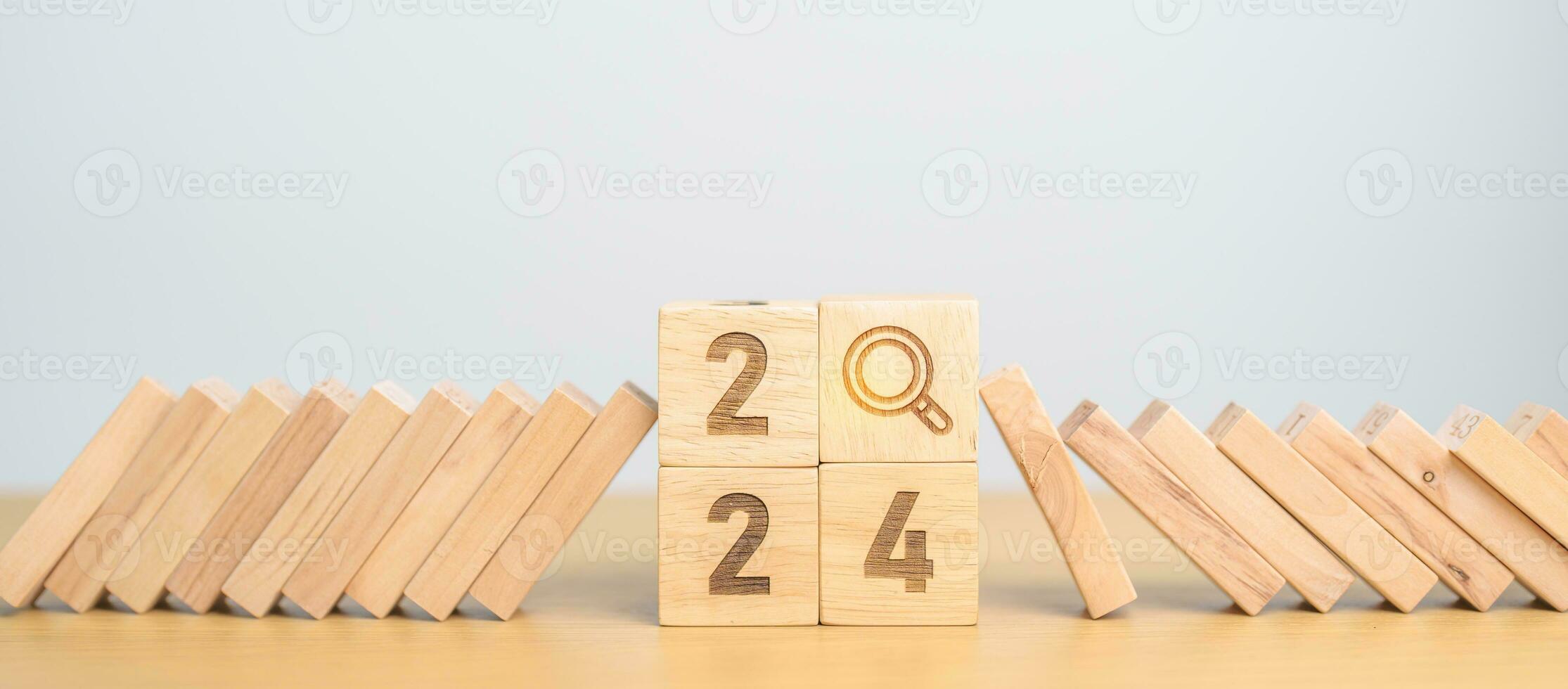 2024 year and falling blocks with magnifying glass icon. SEO, Search Engine Optimization, hiring , Advertising, Risk Management, recession, goal, New Year planning and inflation economy concepts photo