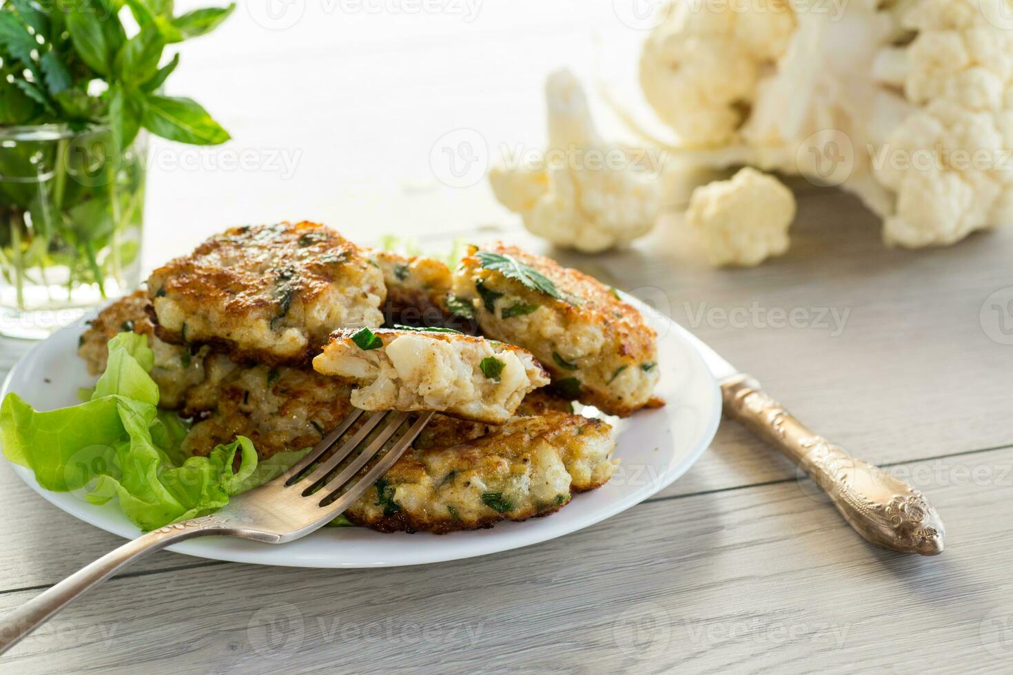 cooked vegetarian fried cauliflower cutlets, in a plate . photo