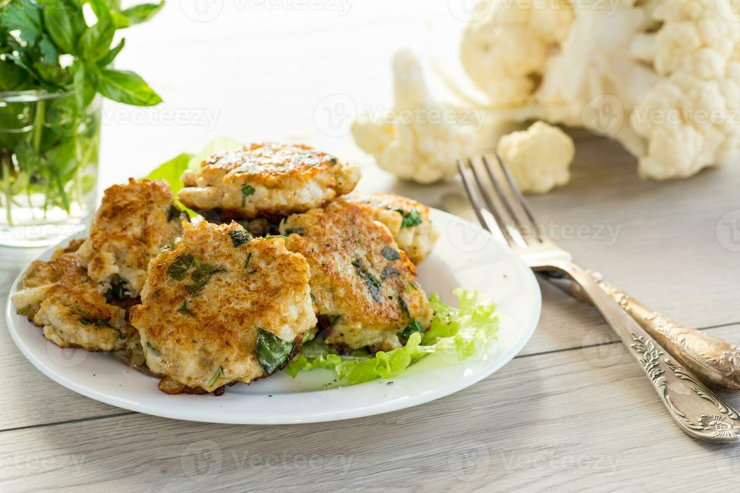 cooked vegetarian fried cauliflower cutlets, in a plate . photo