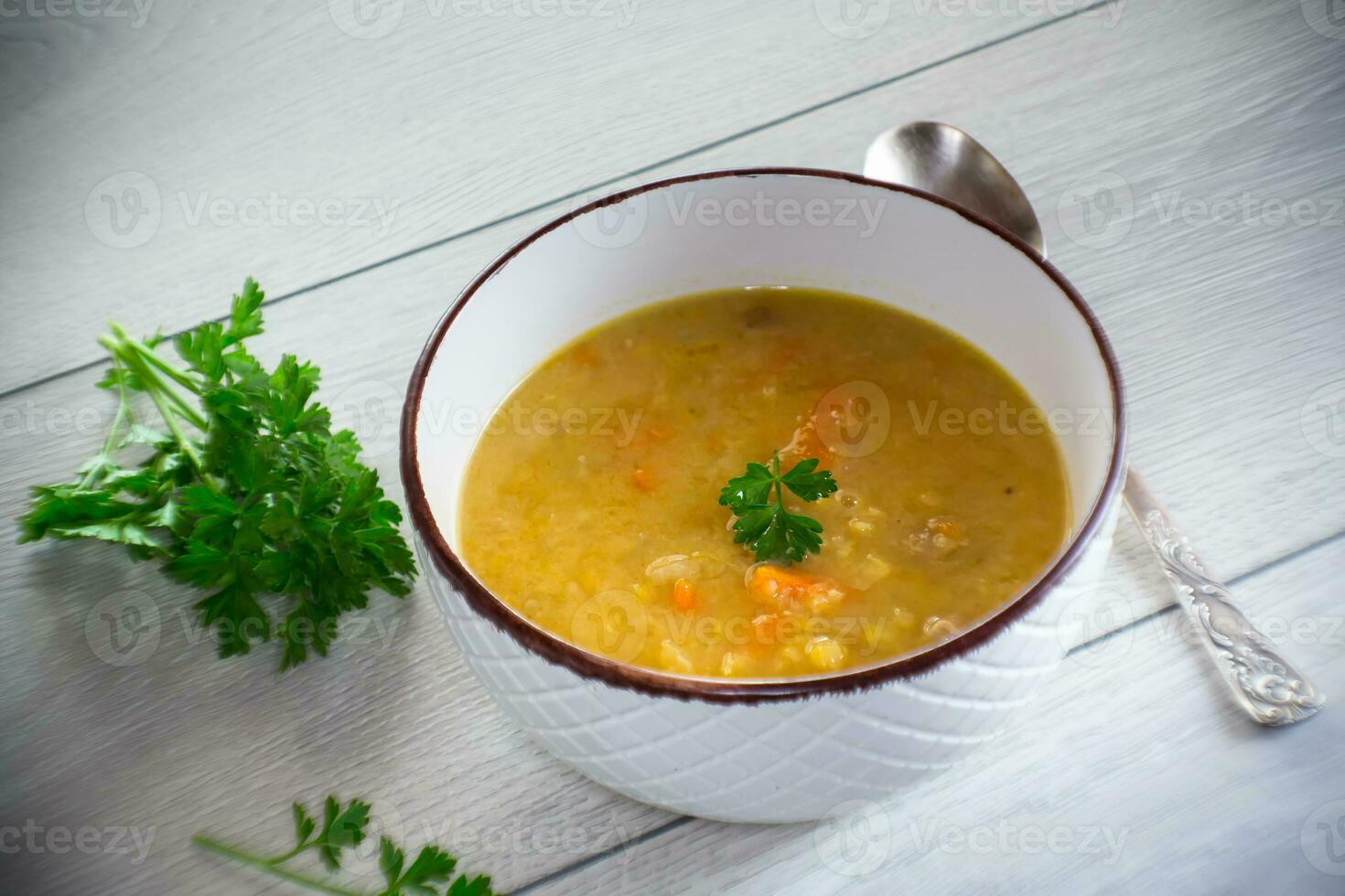 dried pea soup in a plate with herbs photo