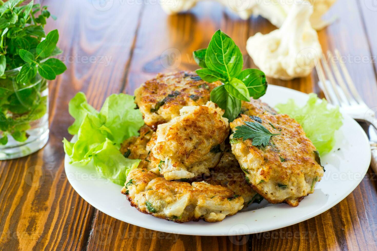 cooked vegetarian fried cauliflower cutlets, in a plate . photo