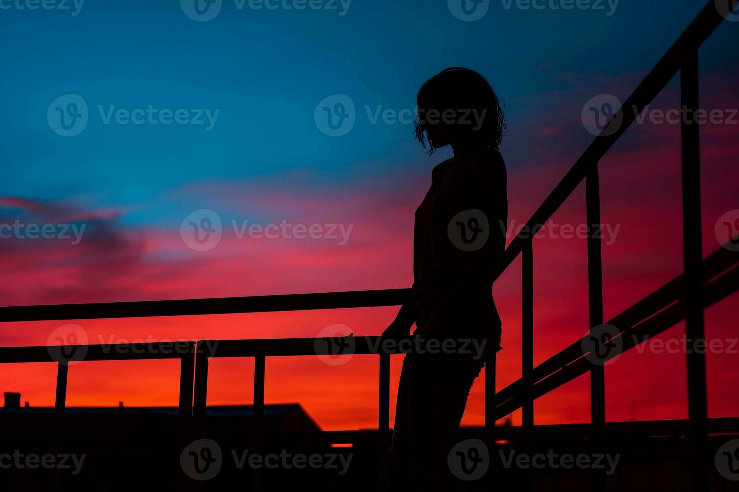 silhouette of a person standing on a railing at sunset generative ai photo