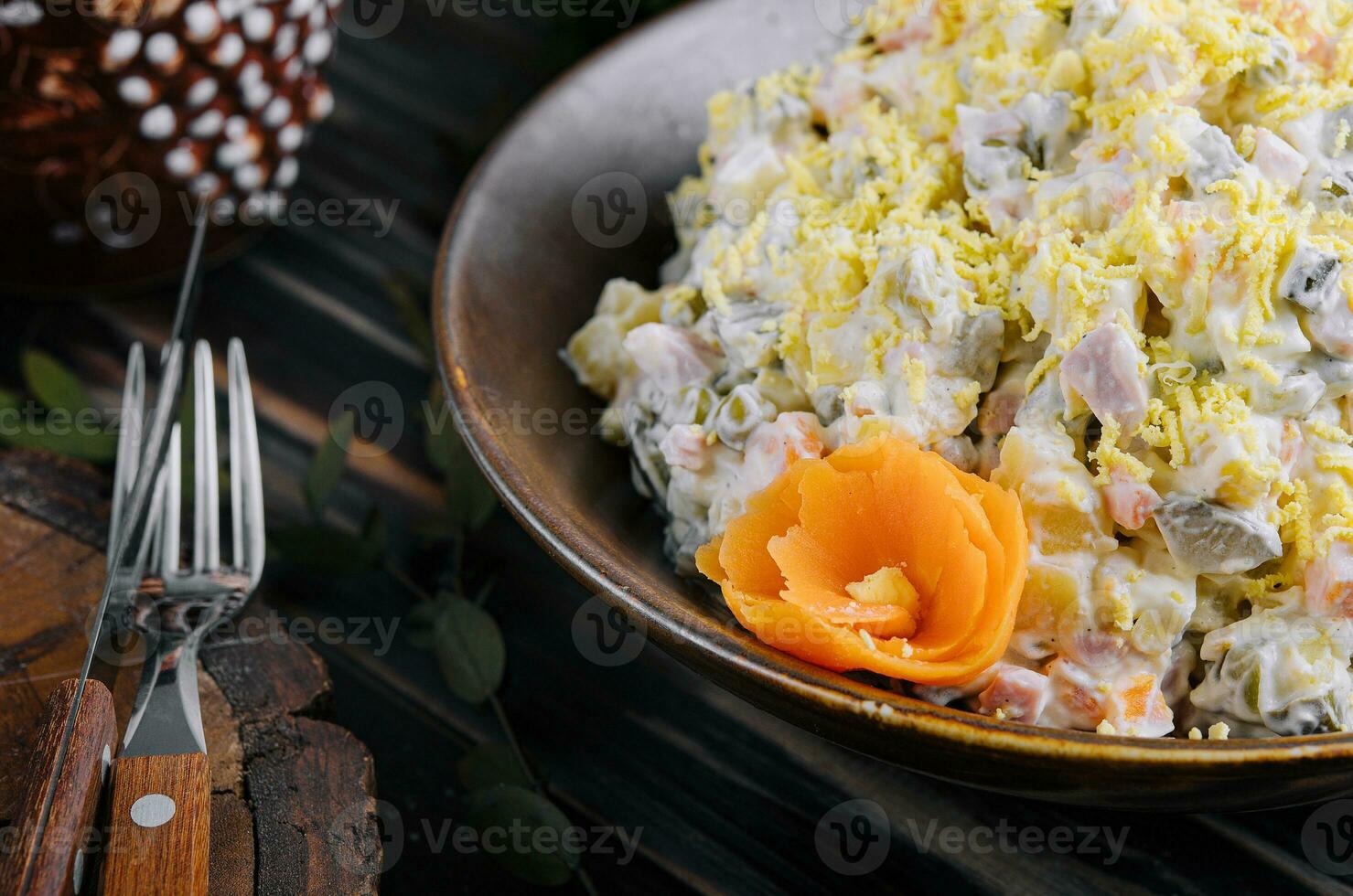 Fresh salad olivier in a ceramic bowl photo
