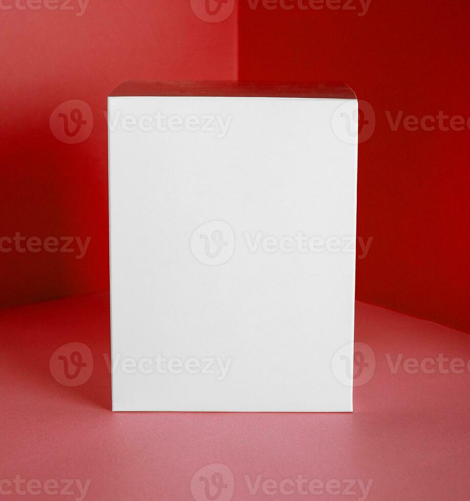 White gift box on red background photo