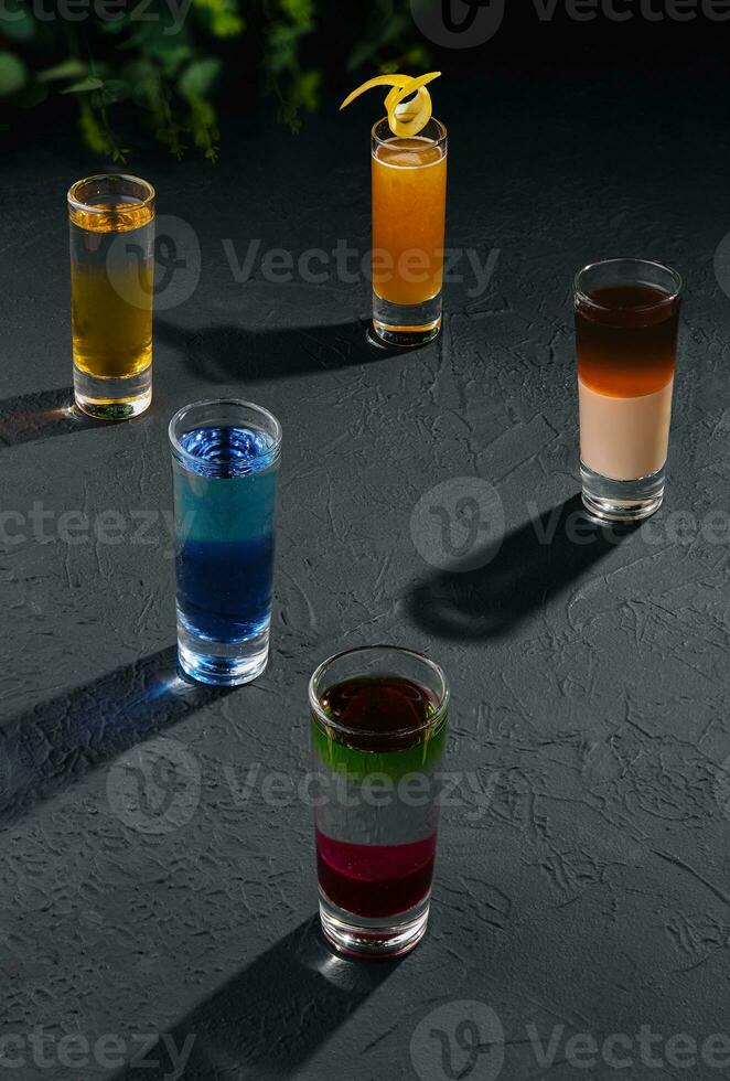 Multicolored shots on dark stone photo