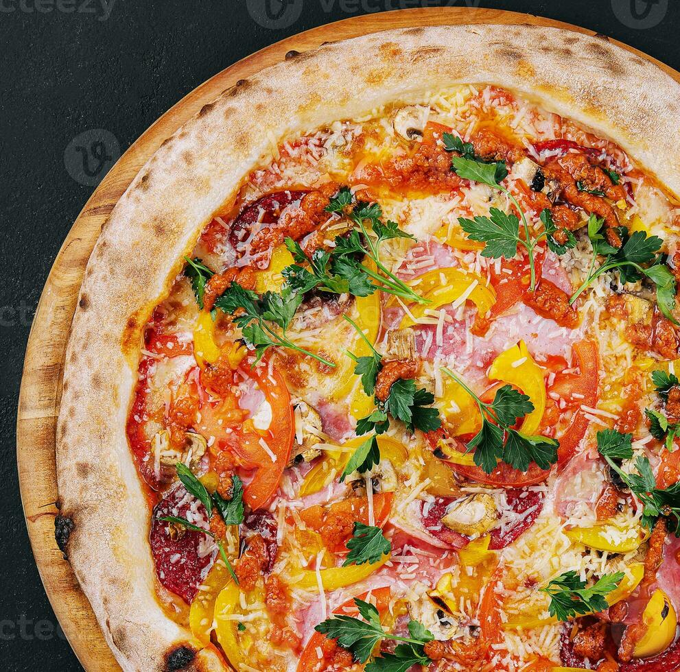Fresh delicious pizza made in a hearth oven with sausage, pepper and tomatoes photo