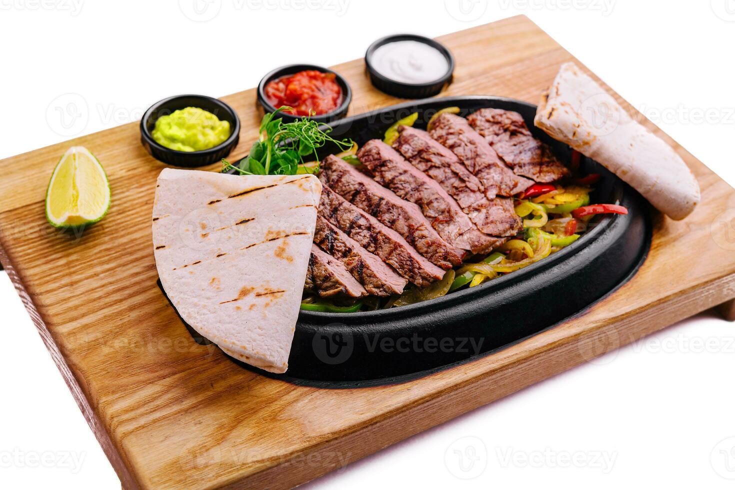 sliced fried meat with grilled vegetables and pita bread photo