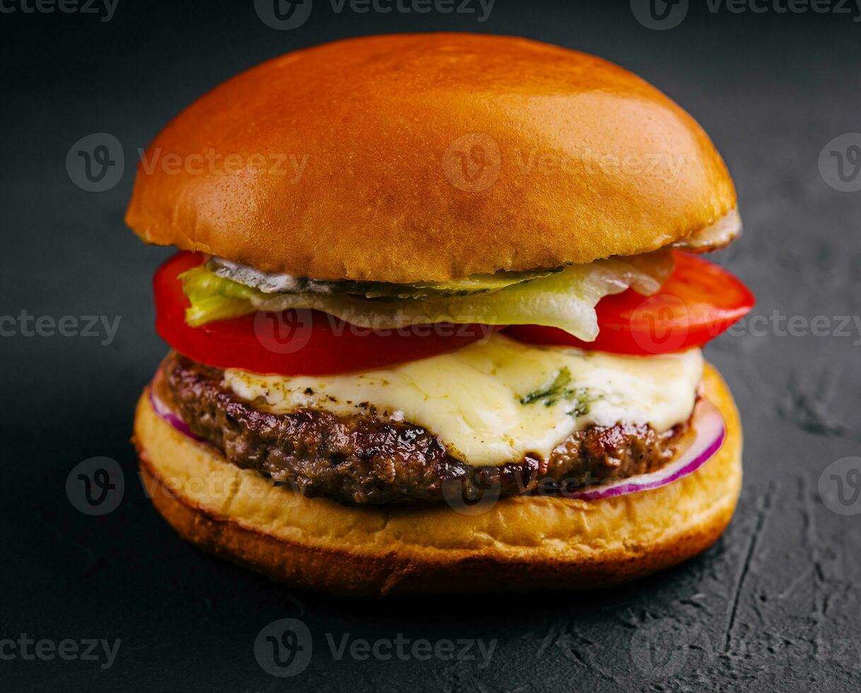 Delicious cheeseburger on a black background photo