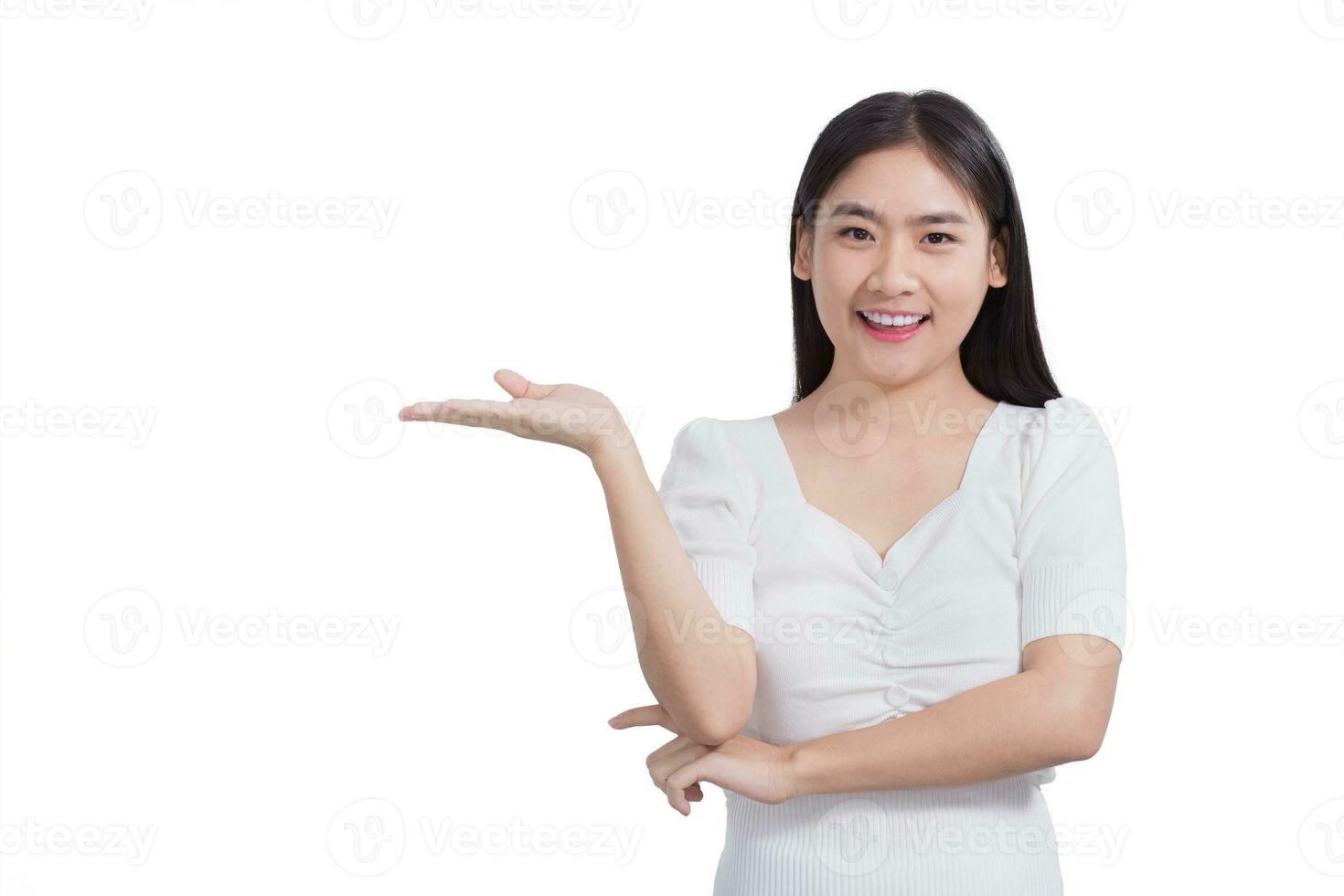 Young Asian beautiful woman in white shirt shows hand to present something while working isolated on white background. photo