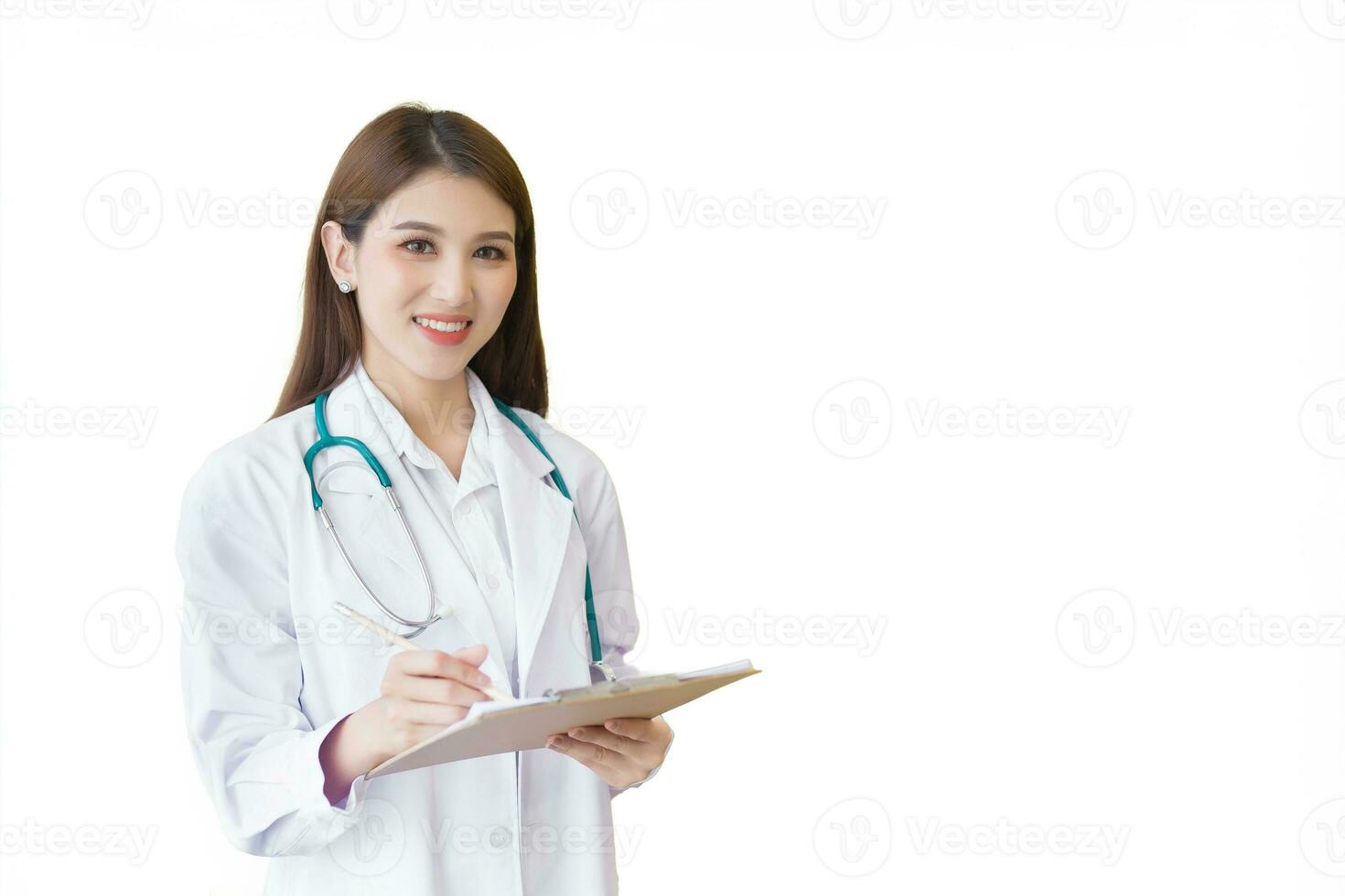 Young professional Asian woman doctor wears medical coat stand stethoscope and interview notepads while working at hospital while isolated on white background in health care concept. photo