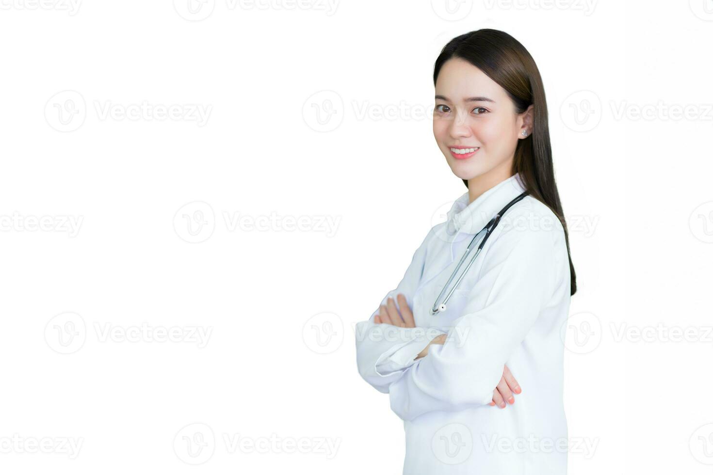 Young professional Asian woman doctor wears medical coat stands confidently and smiles she is arm crossing while she wears white lab coat and stethoscope in hospital while isolated white background. photo