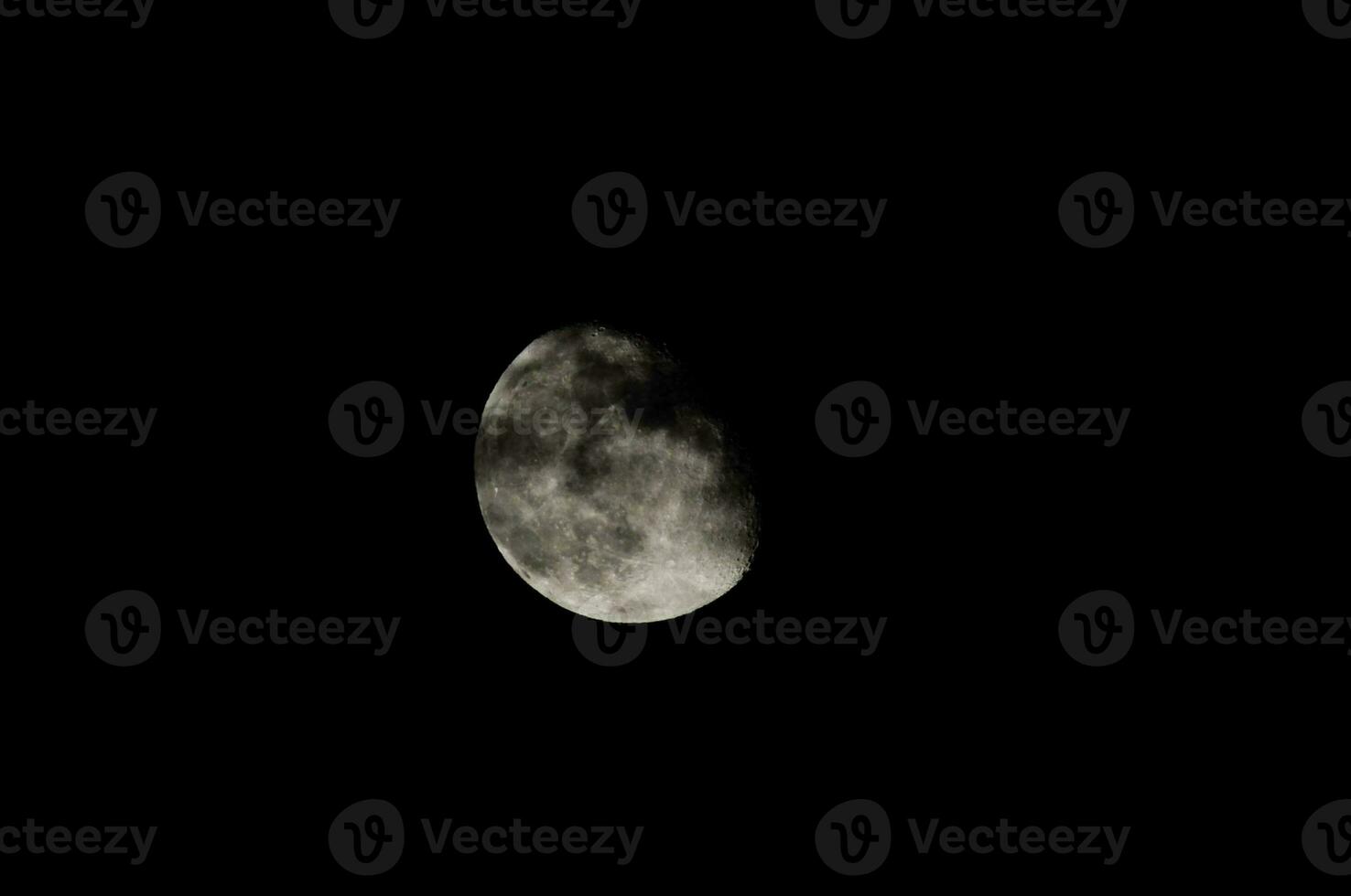 the moon is seen in the dark sky photo