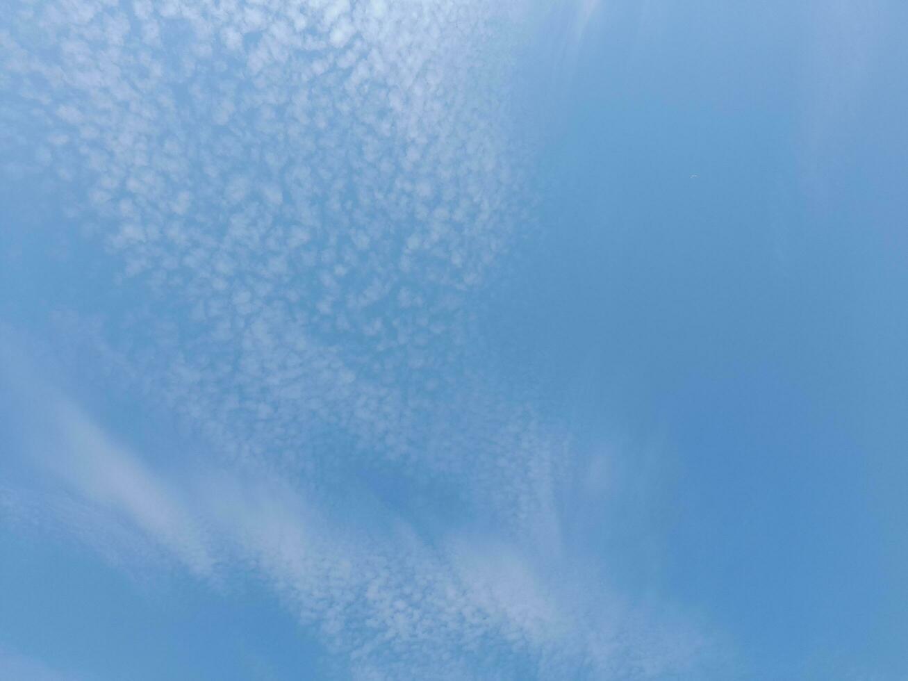 Beautiful white clouds on deep blue sky background. Large bright soft fluffy clouds are cover the entire blue sky. Skyscape on Lombok Island, Indonesia photo