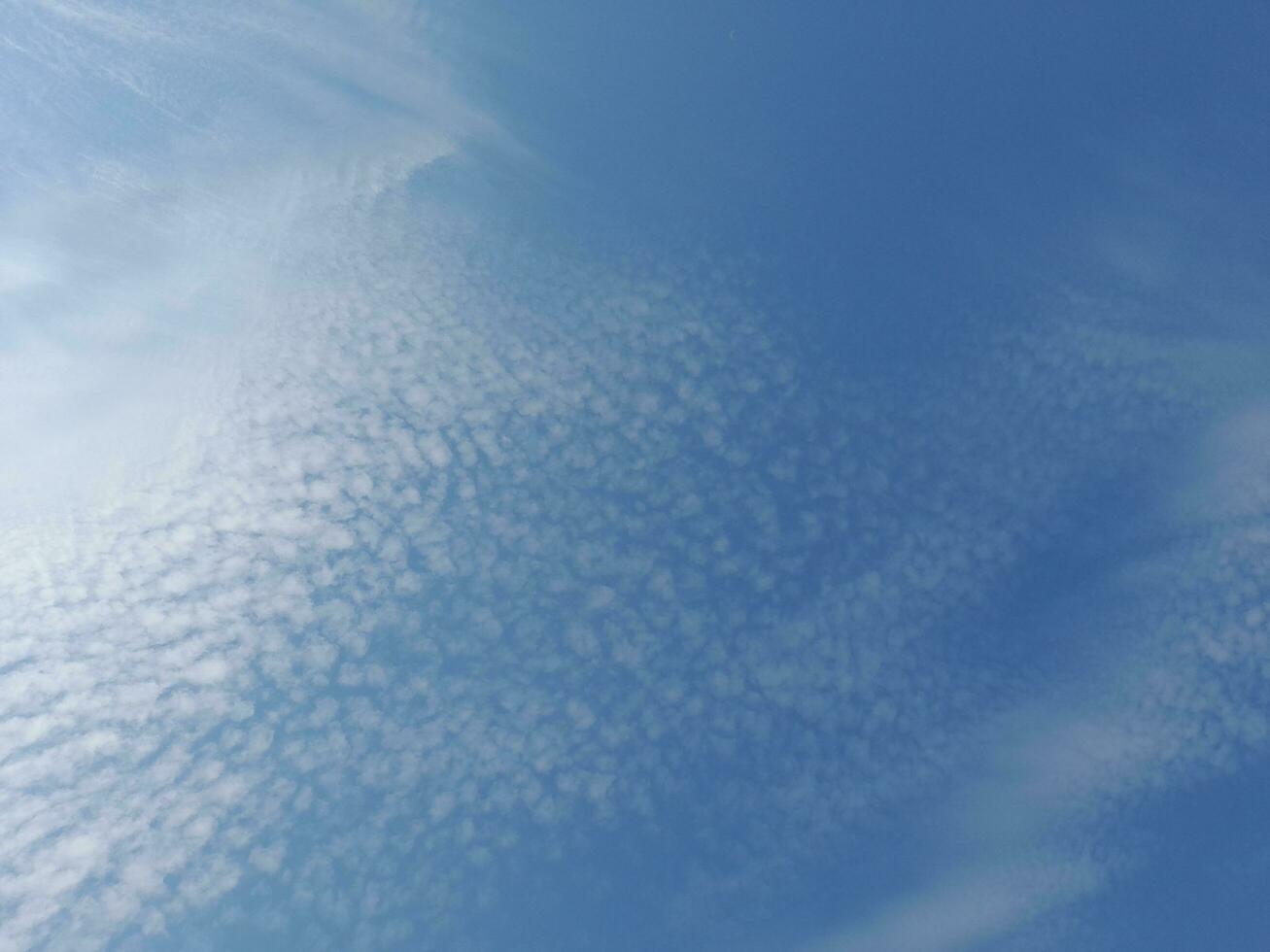 Beautiful white clouds on deep blue sky background. Large bright soft fluffy clouds are cover the entire blue sky. Skyscape on Lombok Island, Indonesia photo