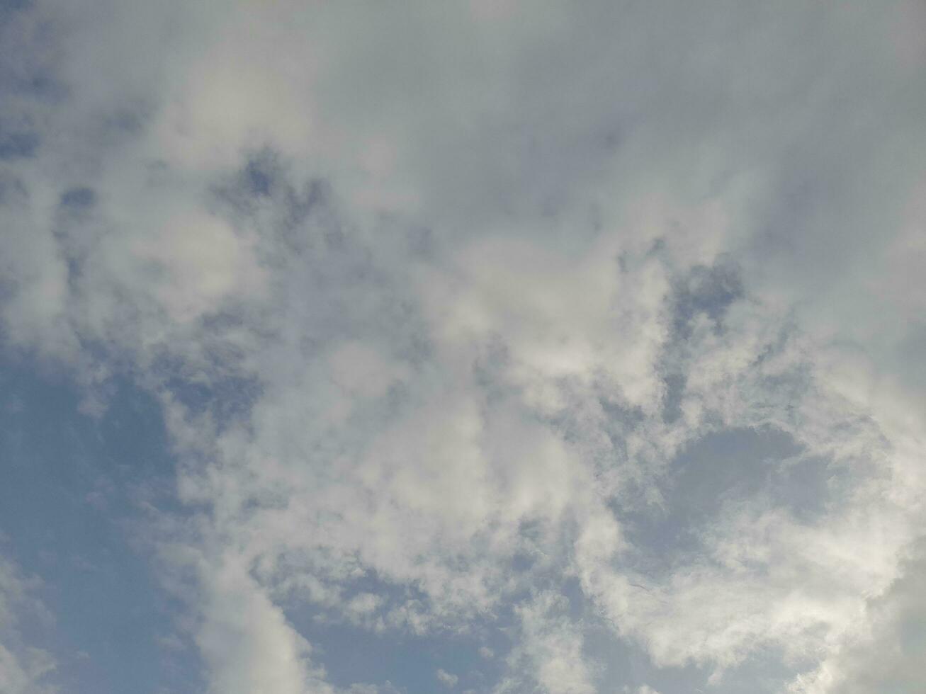 Beautiful white clouds on deep blue sky background. Large bright soft fluffy clouds are cover the entire blue sky. Skyscape on Lombok Island, Indonesia photo