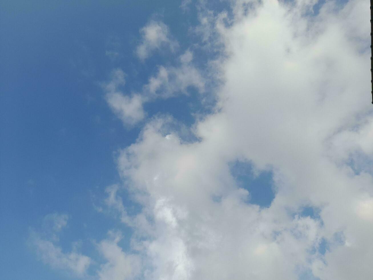 Beautiful white clouds on deep blue sky background. Large bright soft fluffy clouds are cover the entire blue sky. Skyscape on Lombok Island, Indonesia photo