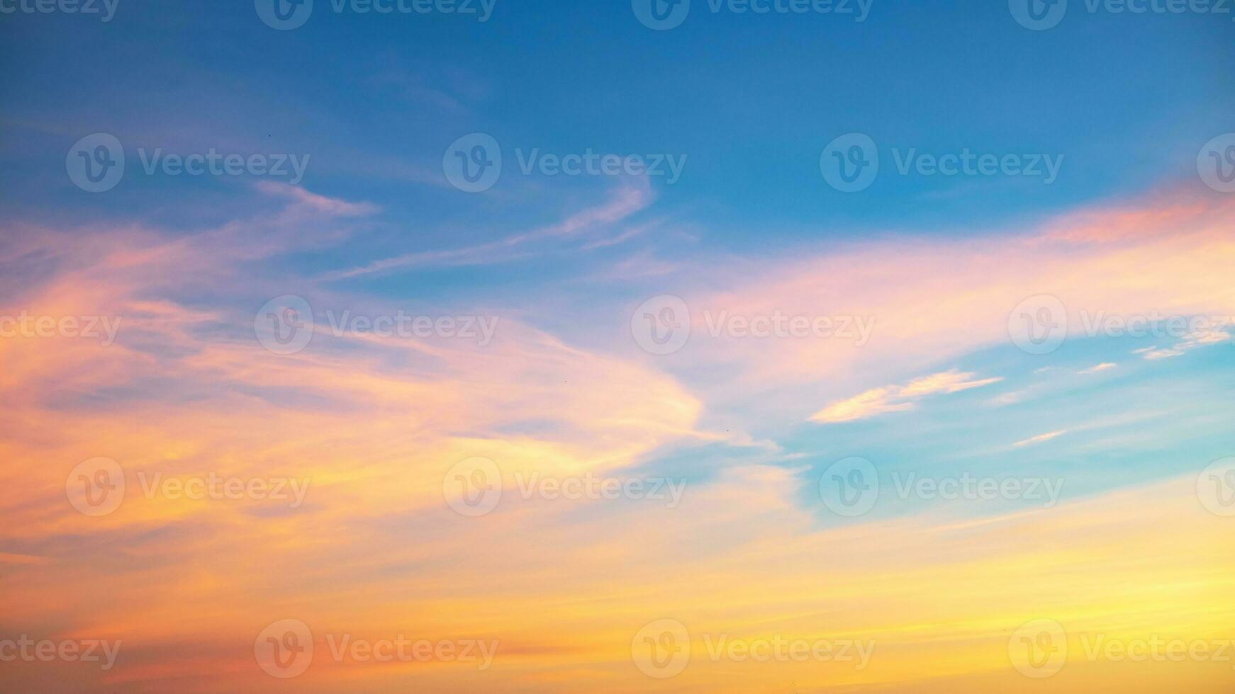 Real amazing Beautiful sunrise and luxury soft gradient orange gold clouds with sunlight on the blue sky perfect for the background, take in everning, Twilight sunset sky with gentle colorful clouds photo