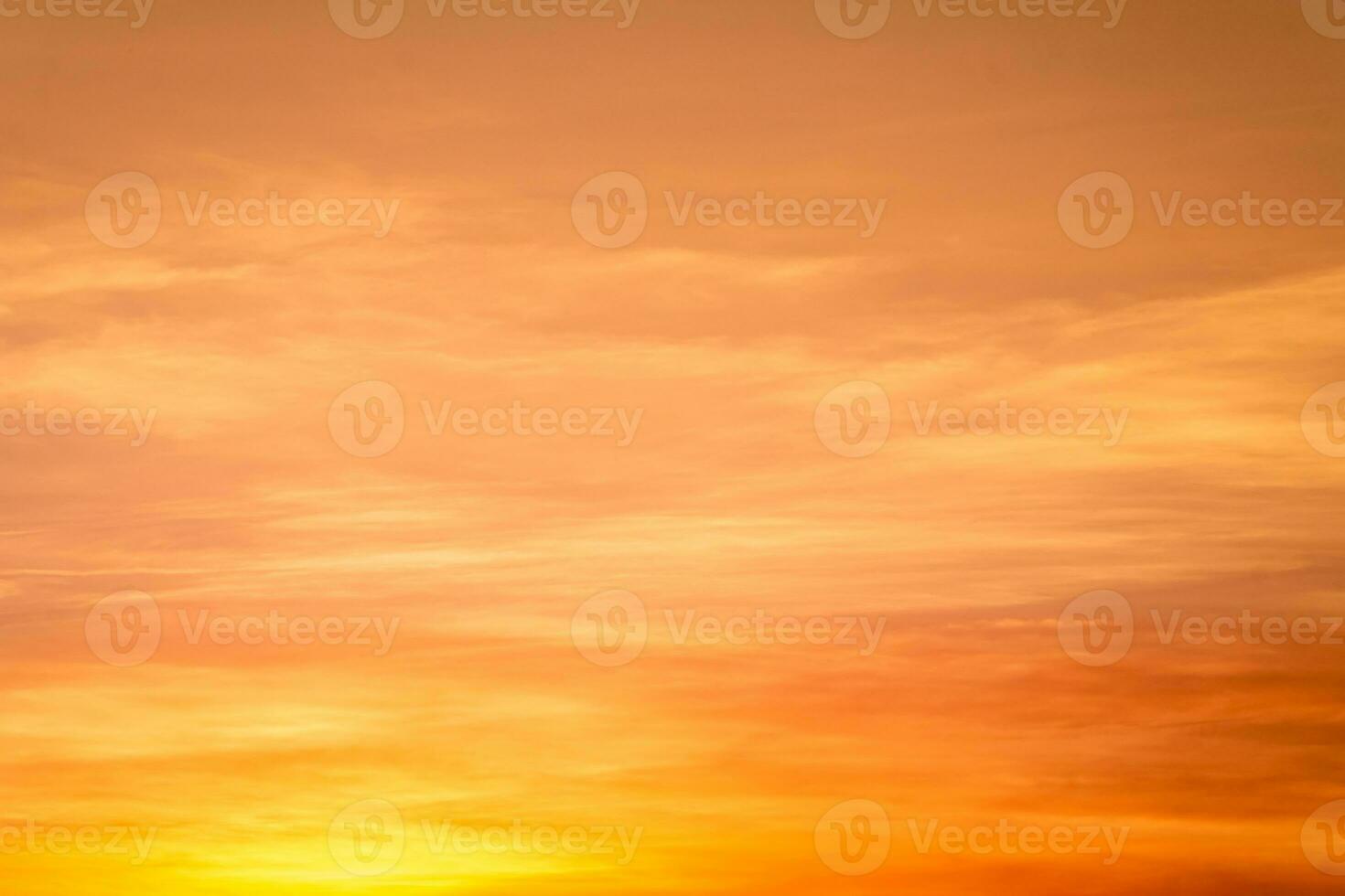 Beautiful of luxury soft gradient orange gold clouds and sunlight on the blue sky perfect for the background, take in everning,Twilight photo