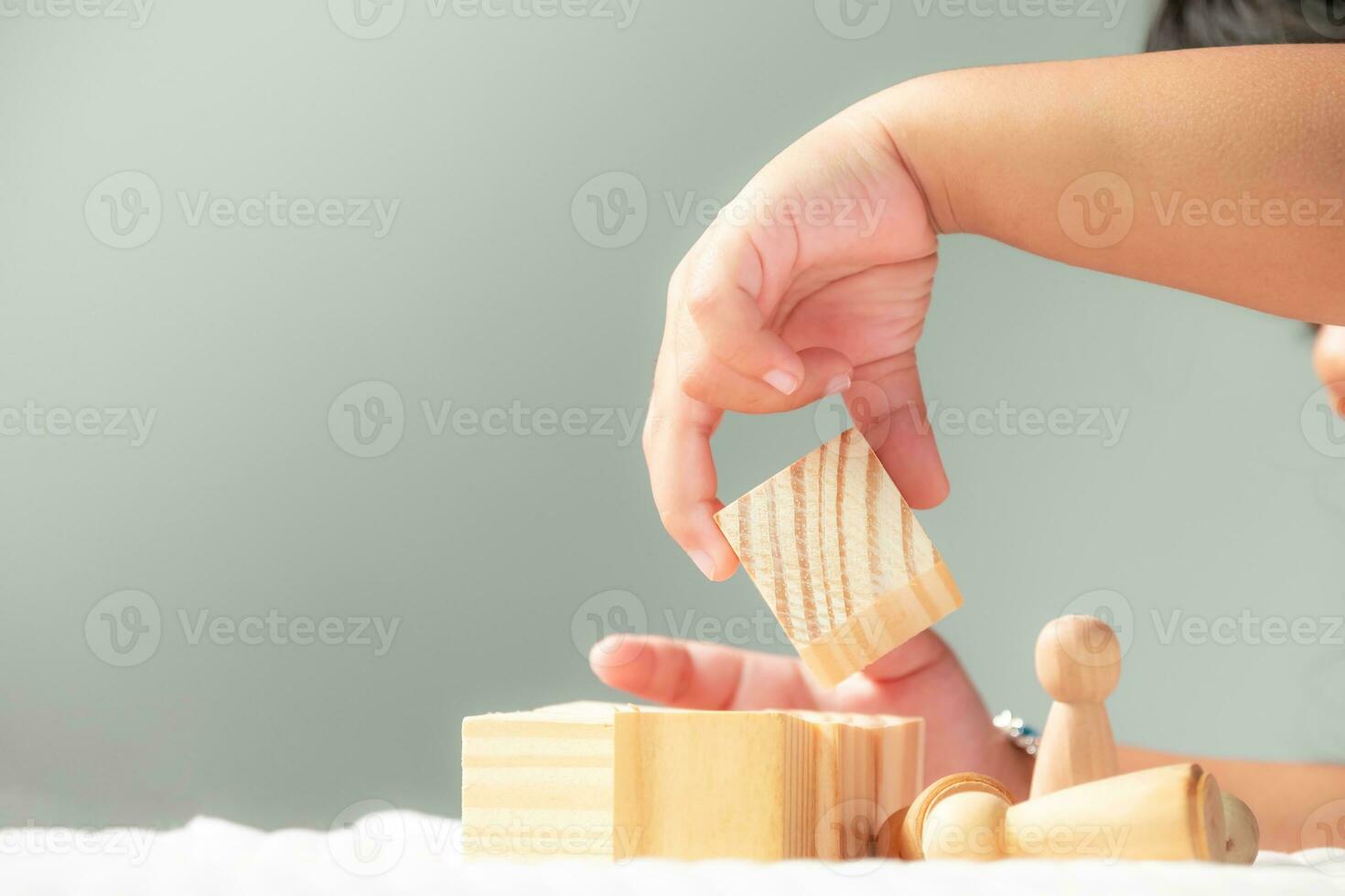 Close up hand's kid playing with wooden bricks or toy, girls relax with playing blocks  and enjoy playing toys, Development of children's learning in early childhood, Cognitive and emotional growth photo
