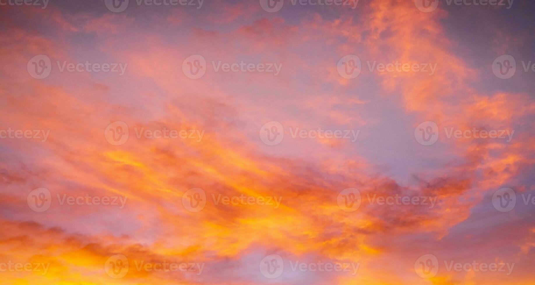 Real amazing Beautiful sunrise and luxury soft gradient orange gold clouds with sunlight on the blue sky perfect for the background, take in everning, Twilight sunset sky with gentle colorful clouds photo