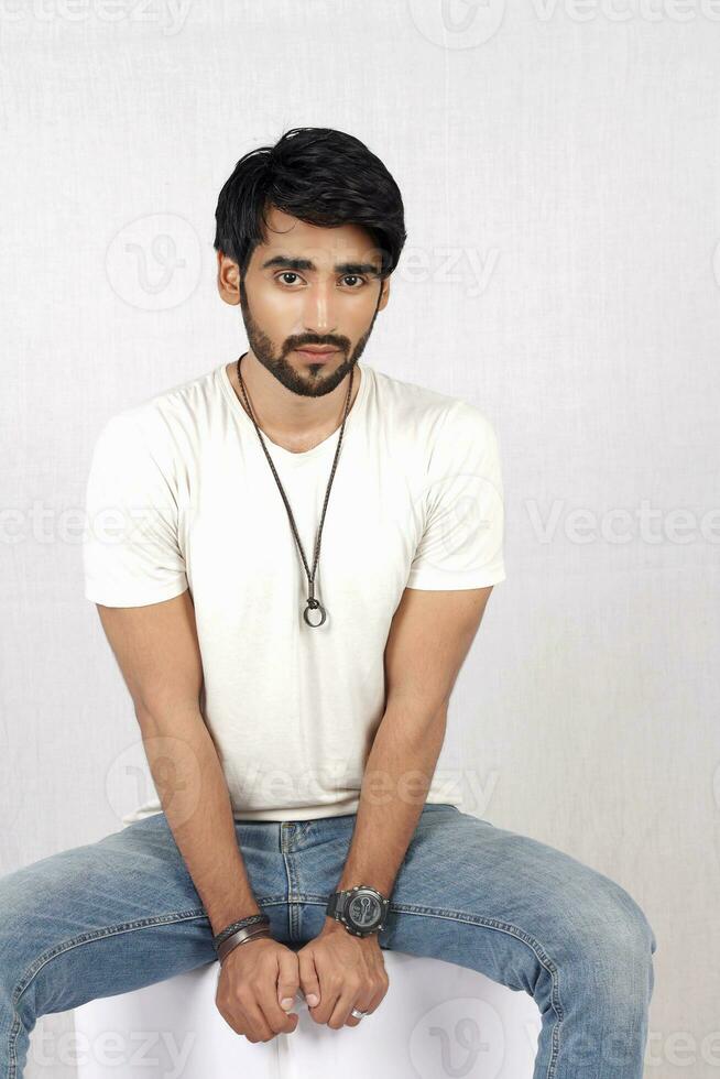 a man sitting on a table with his hands crossed photo