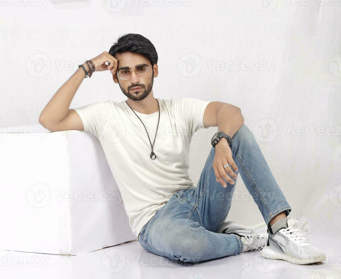 a man sitting on a table with his hands crossed photo