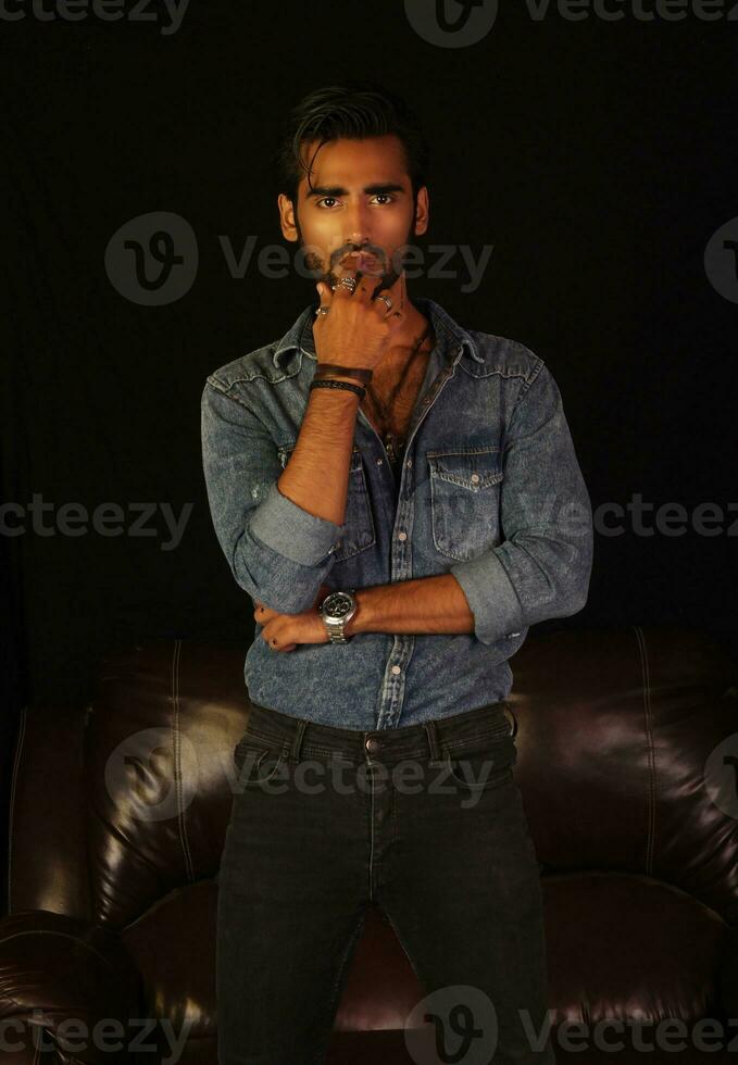 a man standing in front of a couch photo