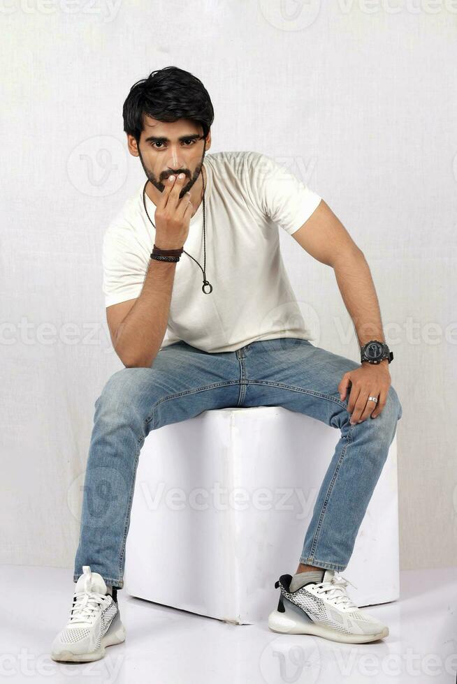 a man sitting on a table with his hands crossed photo