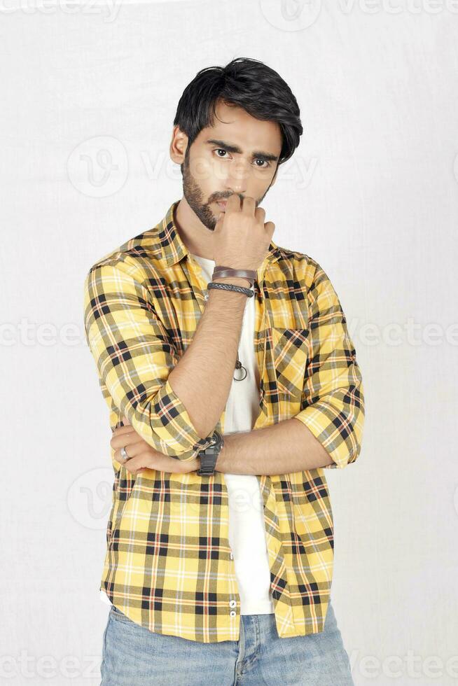 a man in a yellow and black checkered shirt photo