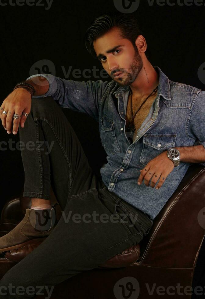 a man standing in front of a couch photo