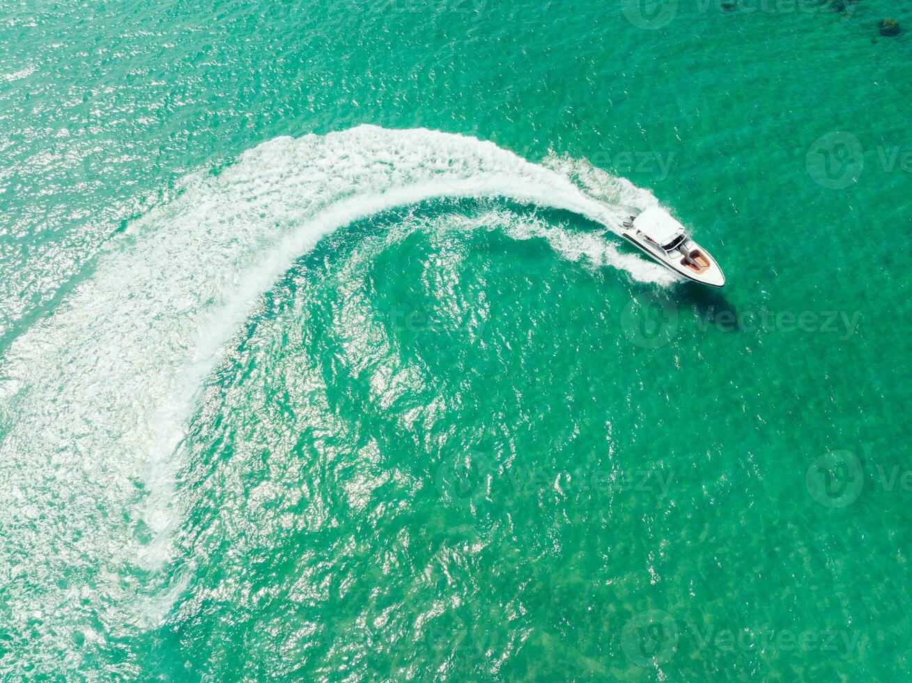 Aerial view of Speed boat at high speed in the aqua sea, Drone view photo