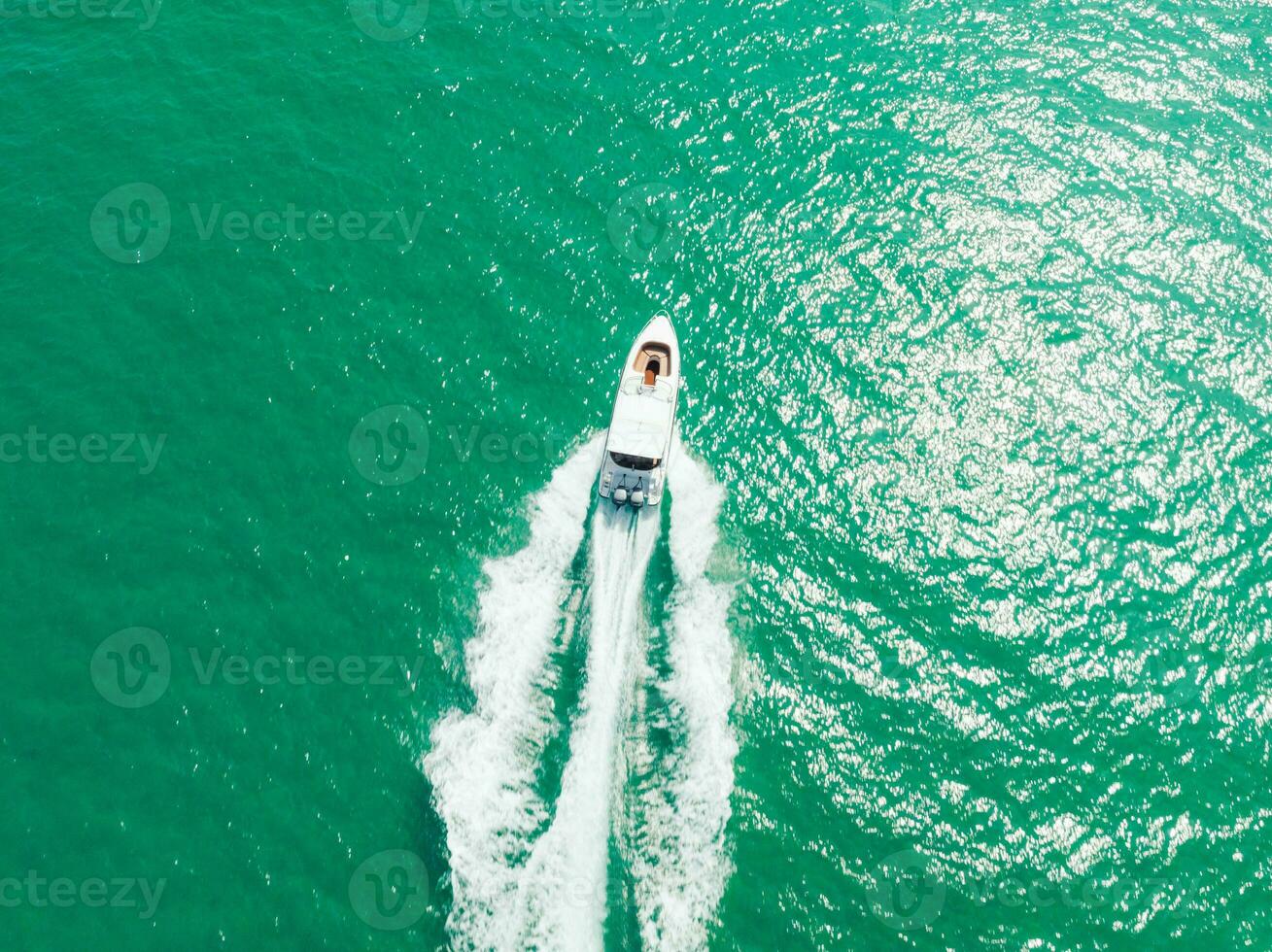 Aerial view of Speed boat at high speed in the aqua sea, Drone view photo