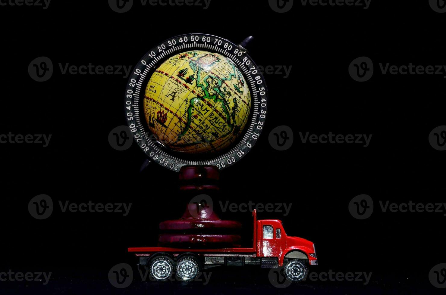 a small model of a truck with a globe on top photo