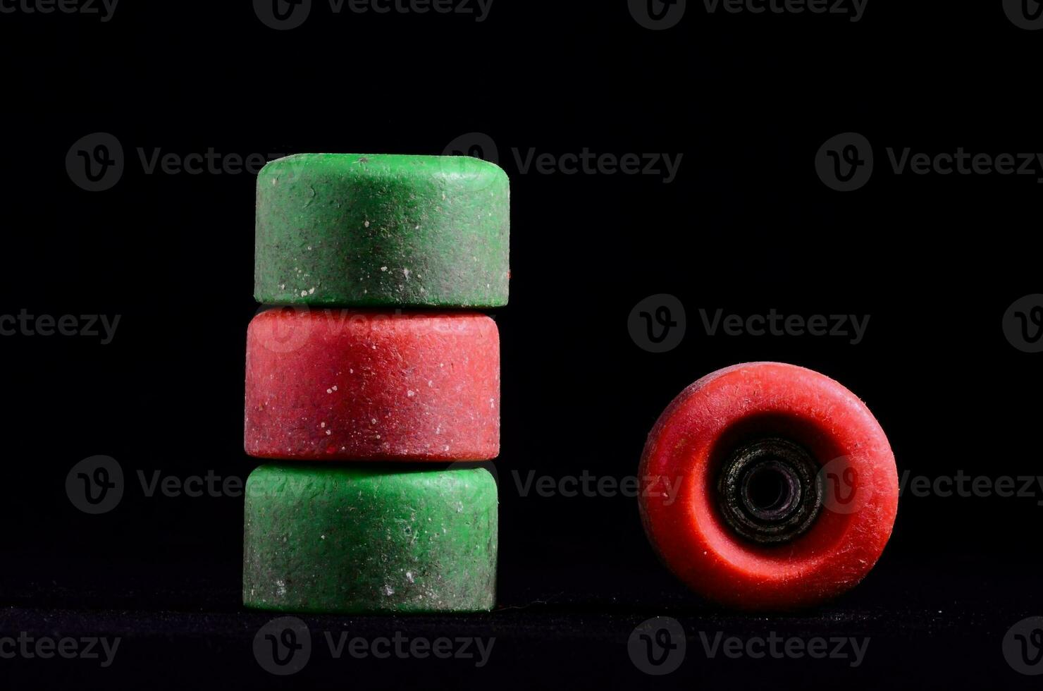 a stack of green and red skateboards on a black background photo