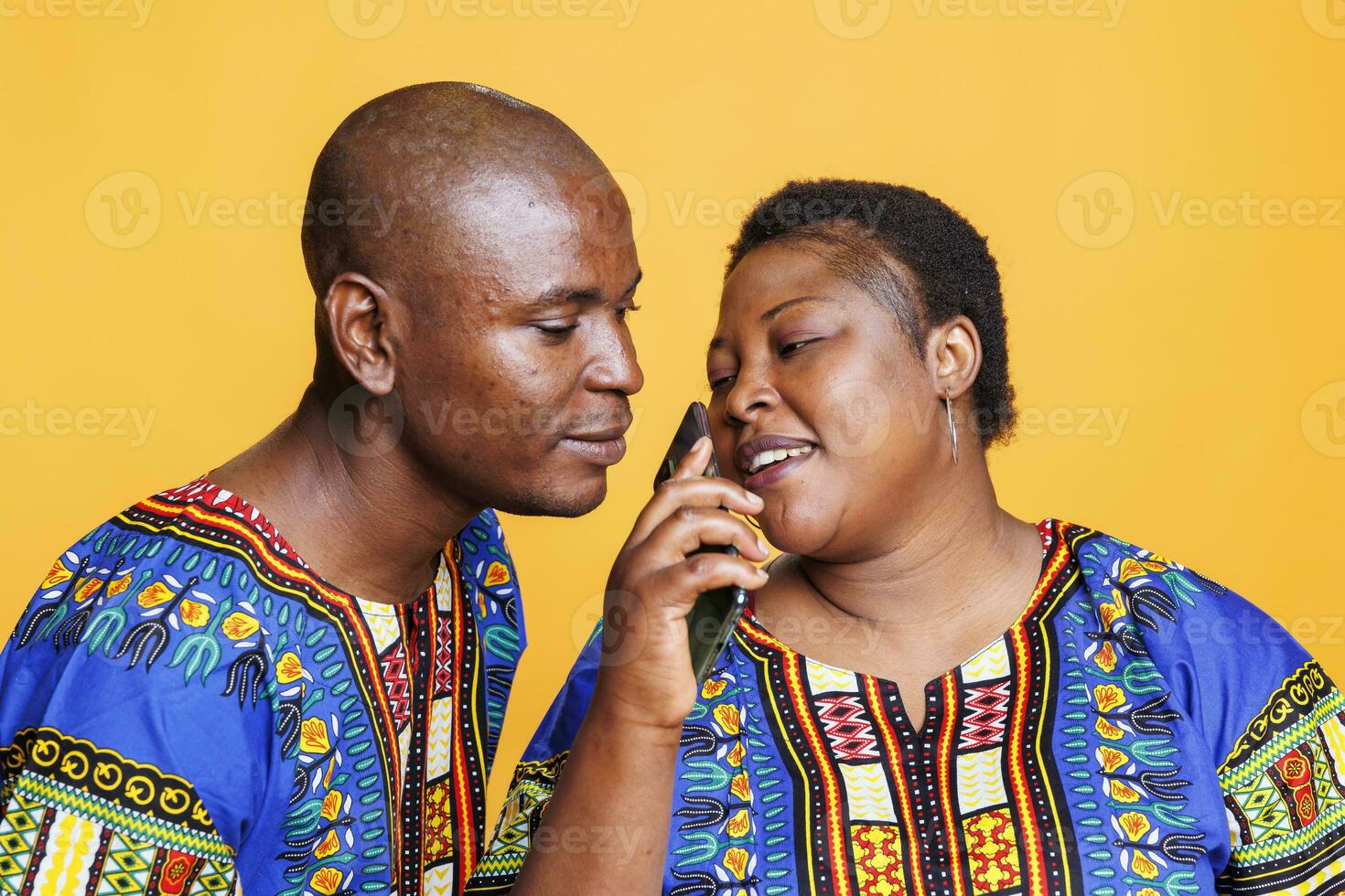 Man and woman couple using mobile phone as microphone. African american singers singing together in smartphone mic, recording song with telephone voice recorder application photo