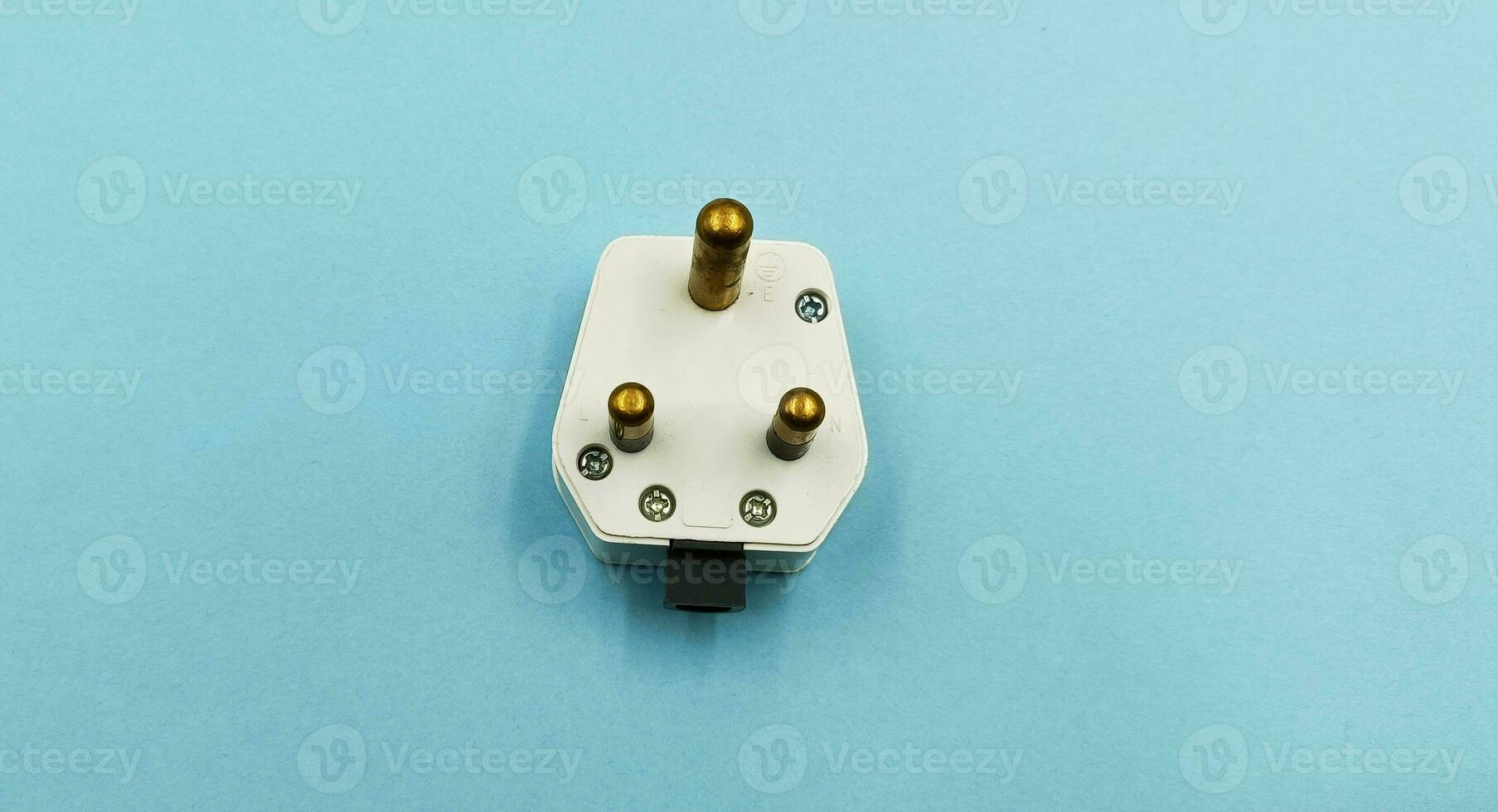 3 pin power plug on blue background photo