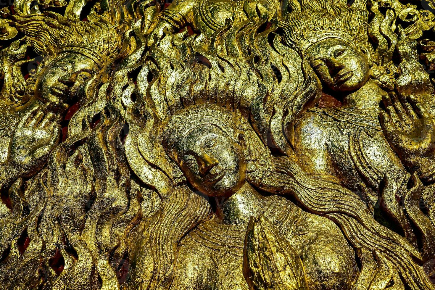 golden statues of the buddha and other gods photo