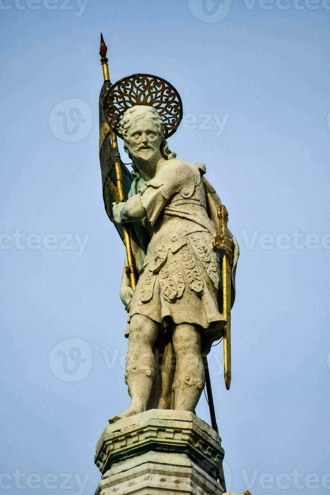 statue of saint st patrick on the top of the tower photo