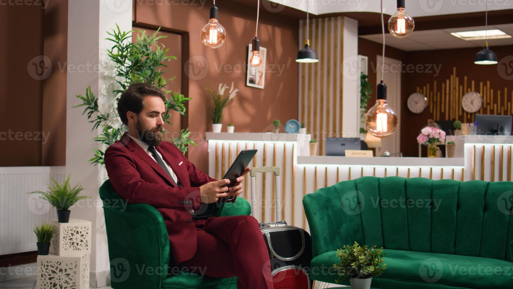 Business associate reads files on tablet to kill time before starting official meeting, lounge area. Entrepreneur preparing speech notes for executive board presentation, travelling for work. photo