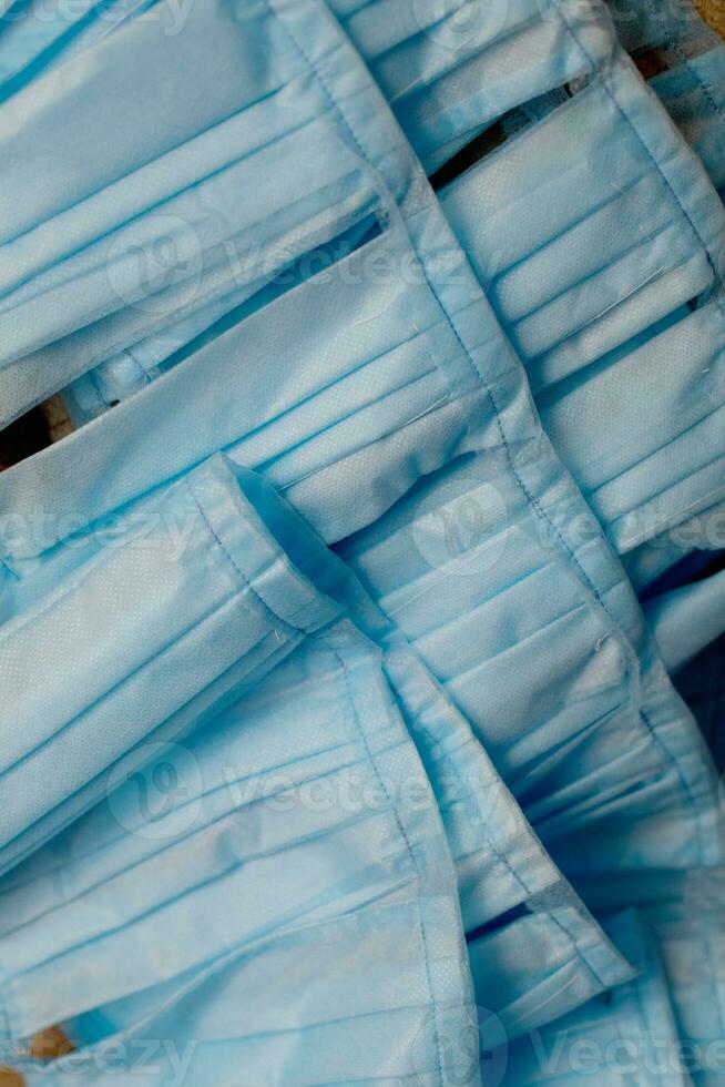medical mask production workers are organizing masks to prepare for epidemic. A lot of uncut medical face masks. Industrial production of masks. photo