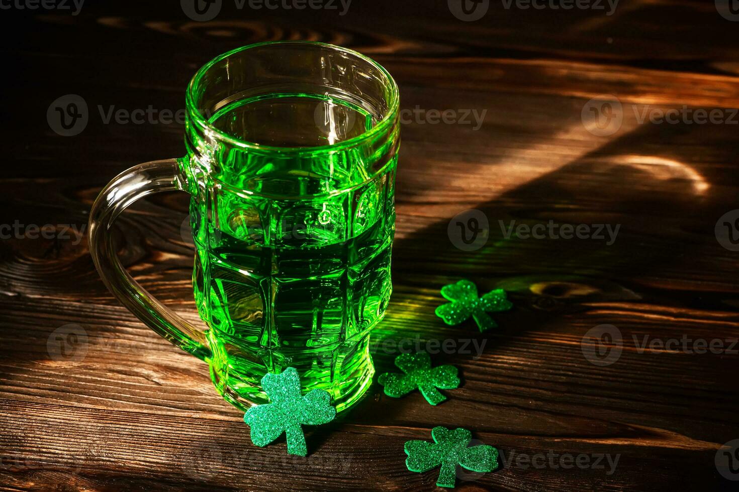 celebrate St. Patrick's Day. Glasses of Green Beer pint on a wooden bar counter, decorated with shamrock leaves. 17 birch. Traditional drink in the light photo