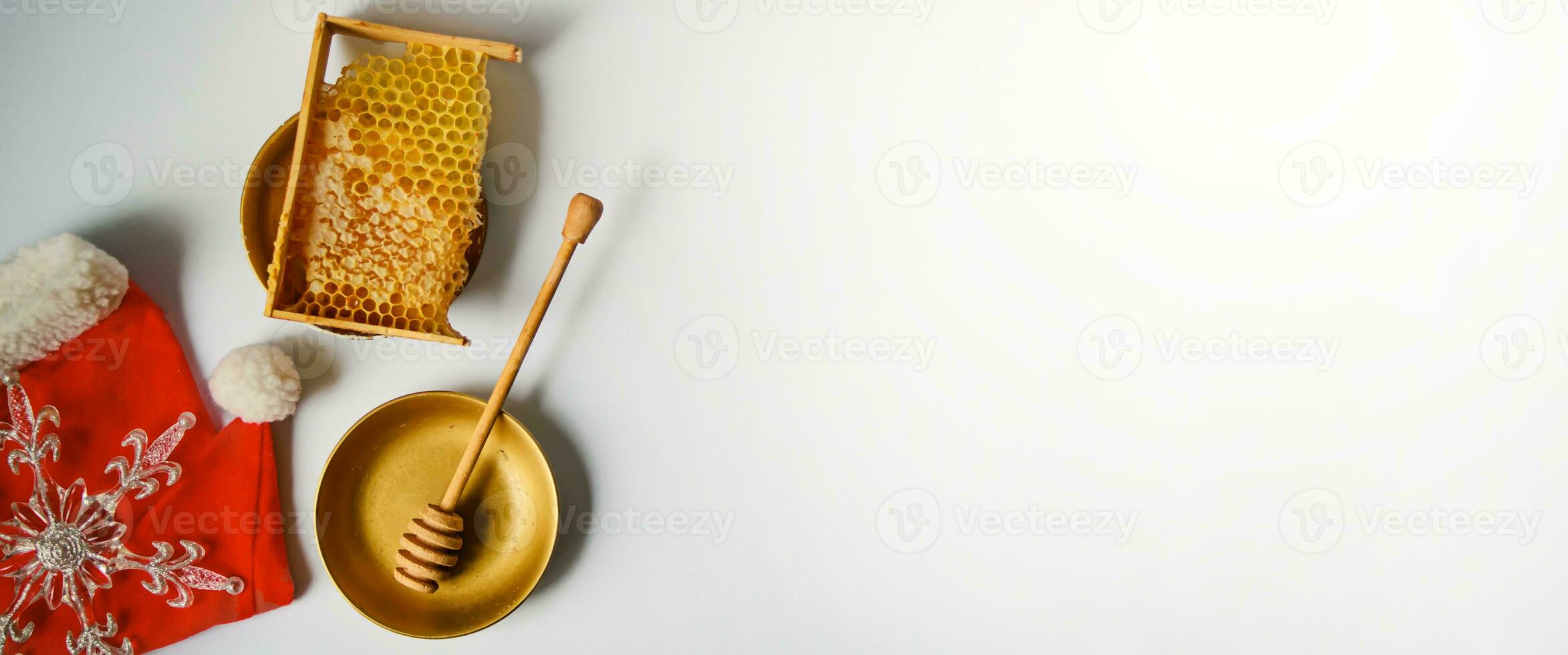 broken yellow honeycomb with honey near alarm clock on table. Honey products. healthy natural food concept. christmas and new year background for beekeeping photo