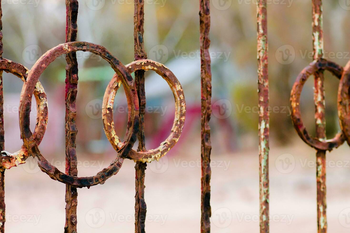 A rusty fence at an abandoned resort on the beach. A fence of iron rods photo