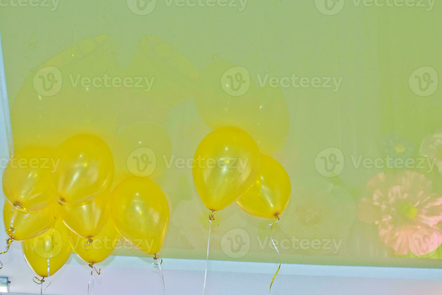 Yellow balls on the ceiling. Registration of children's holidays. Decoration of the hall with balls. photo