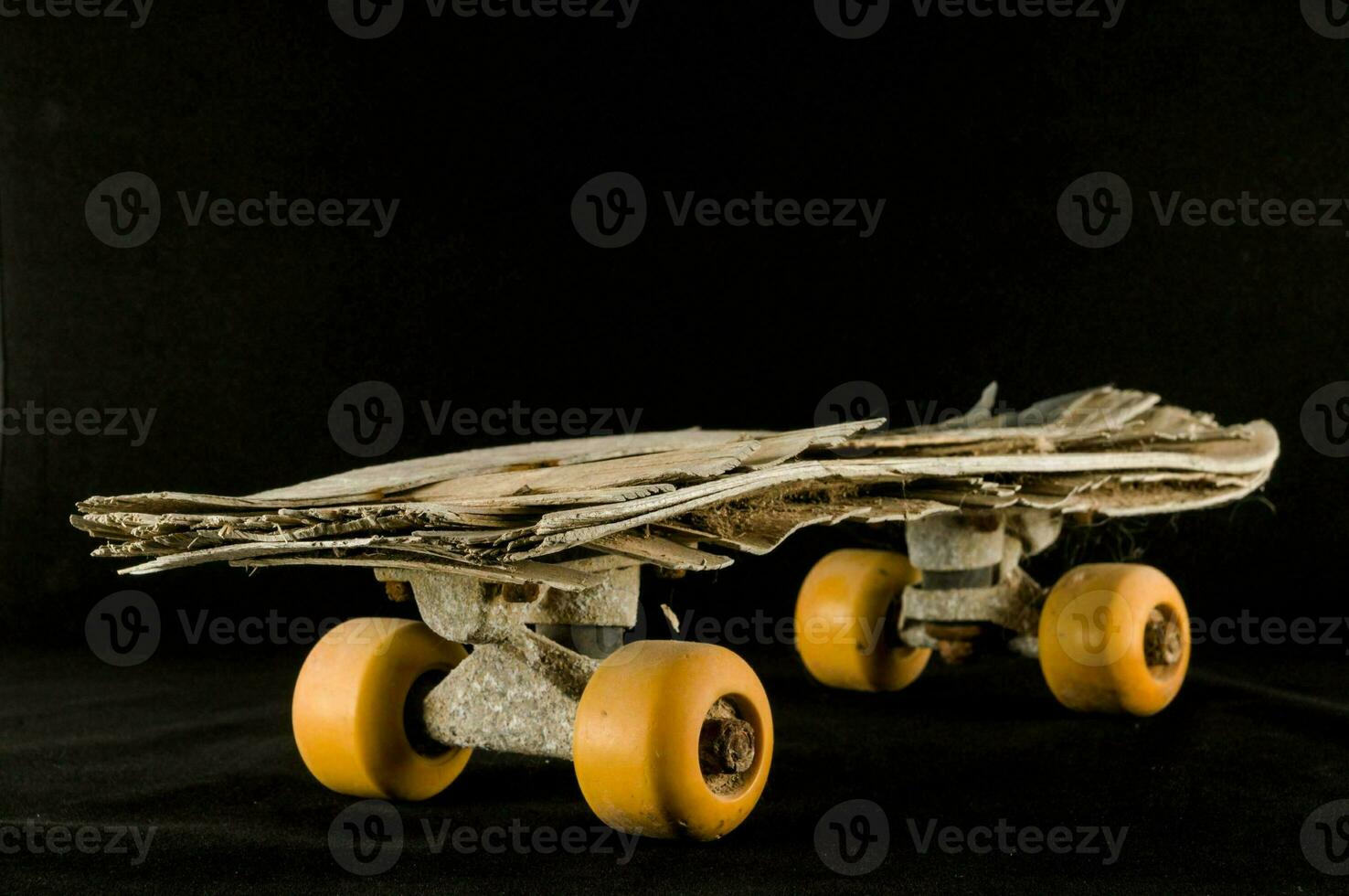 a skateboard made out of wood and yellow wheels photo