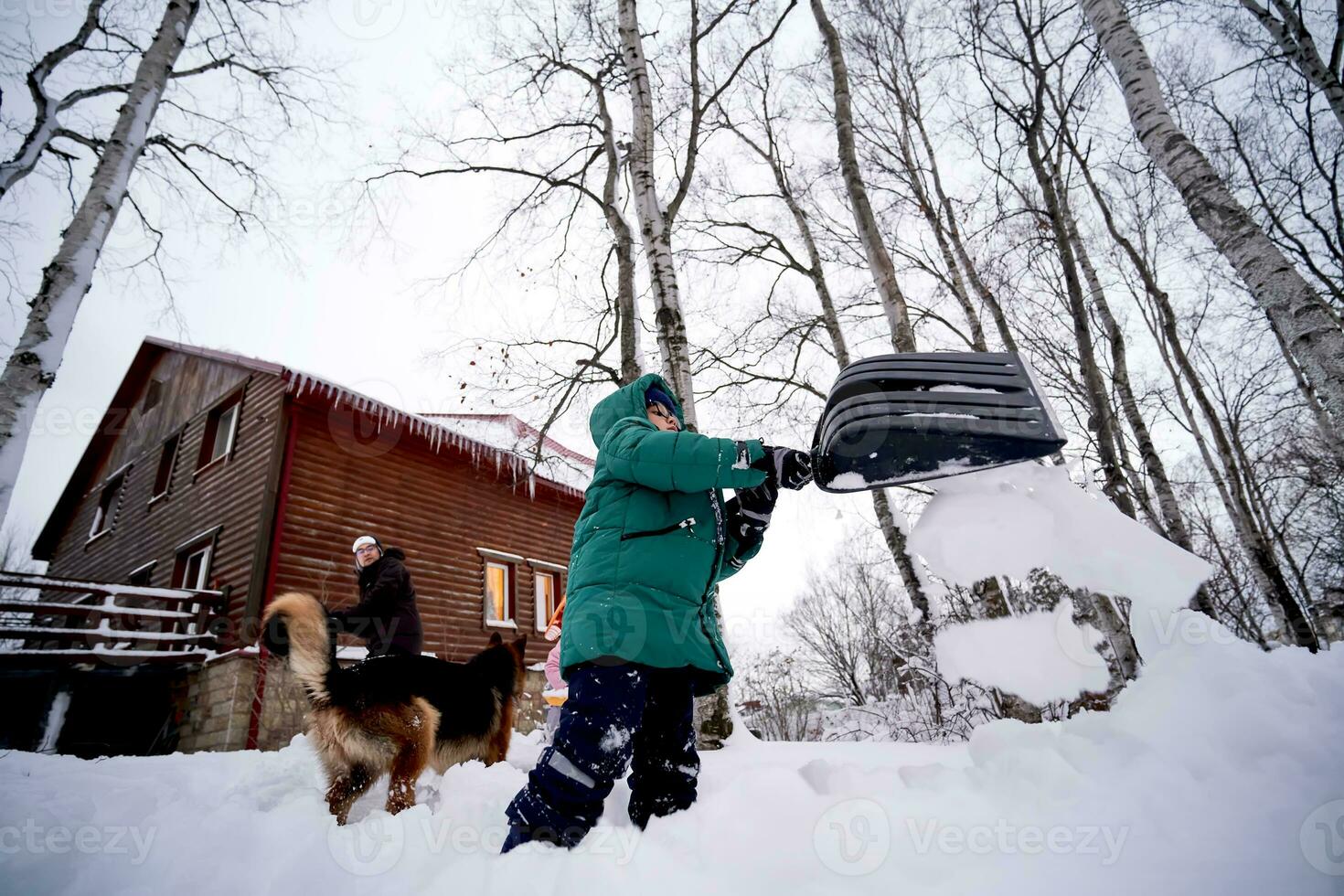 A family builds a slide in the yard in winter. photo