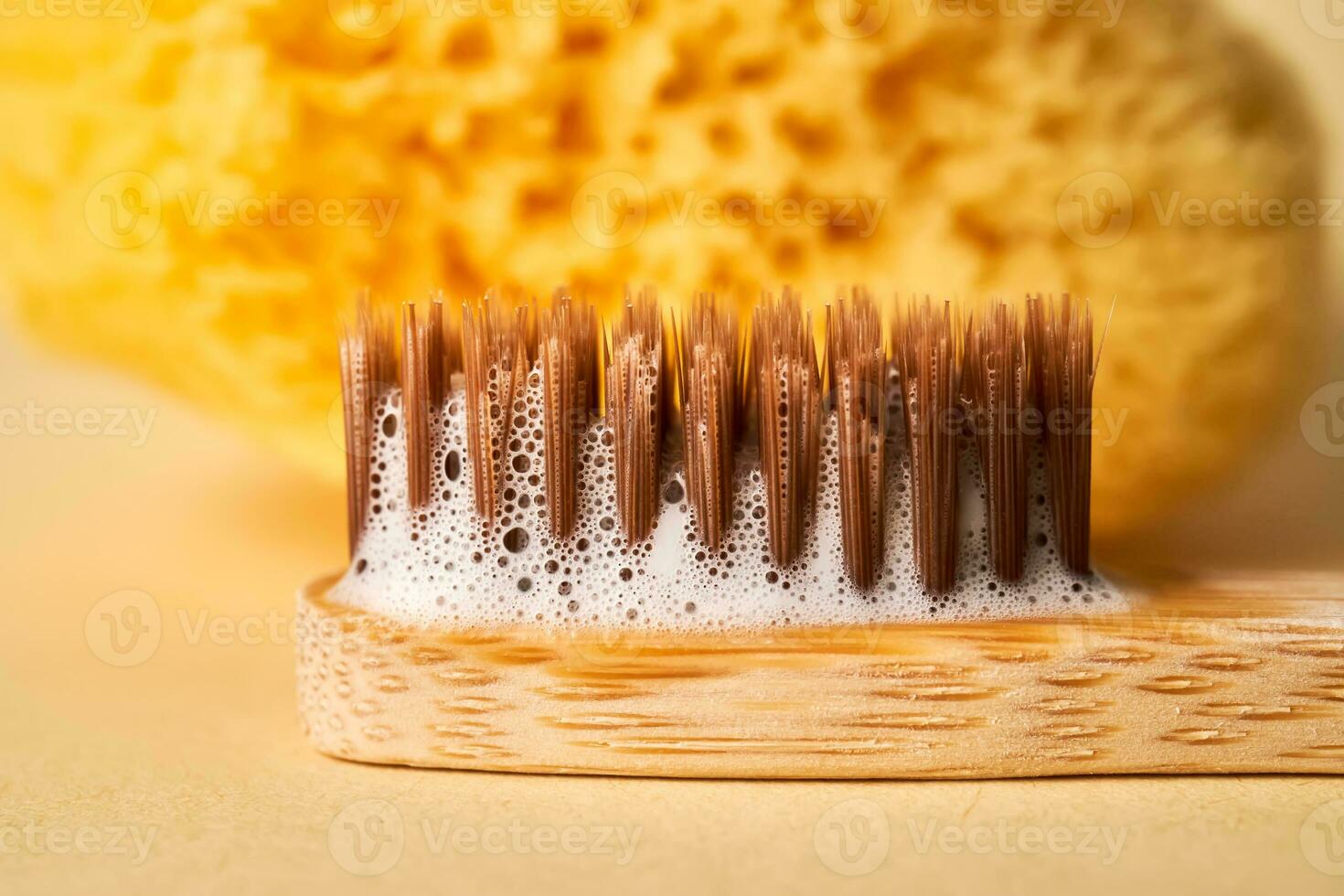 Toothbrush with toothpaste foam close-up. photo
