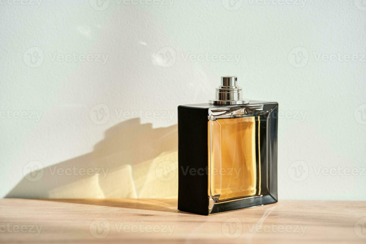 A bottle of perfume in the rays of the sun. photo