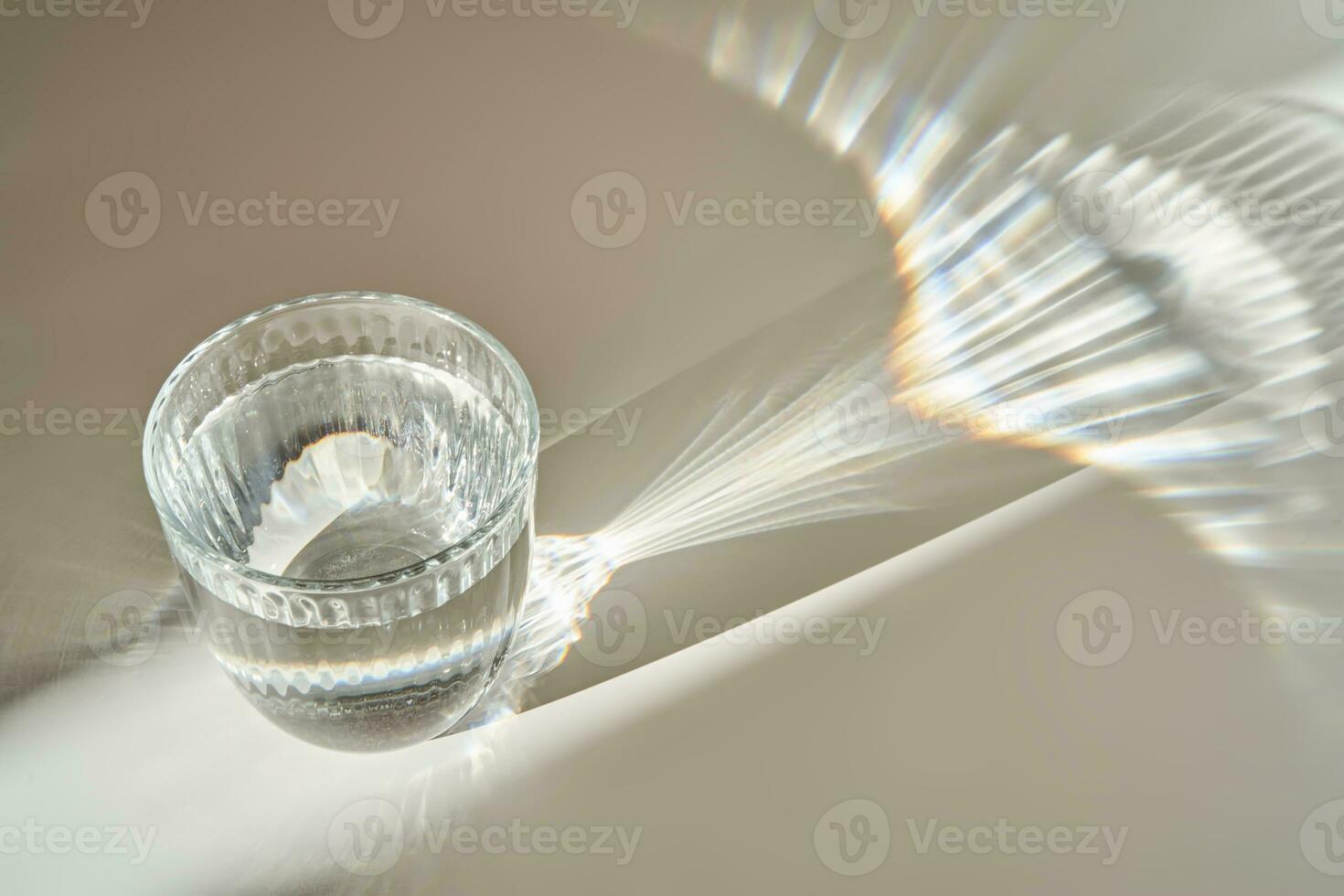 A glass of clean drinking water in the morning sun. photo