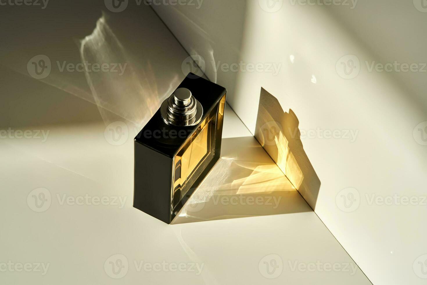 A bottle of perfume in the rays of the sun. photo